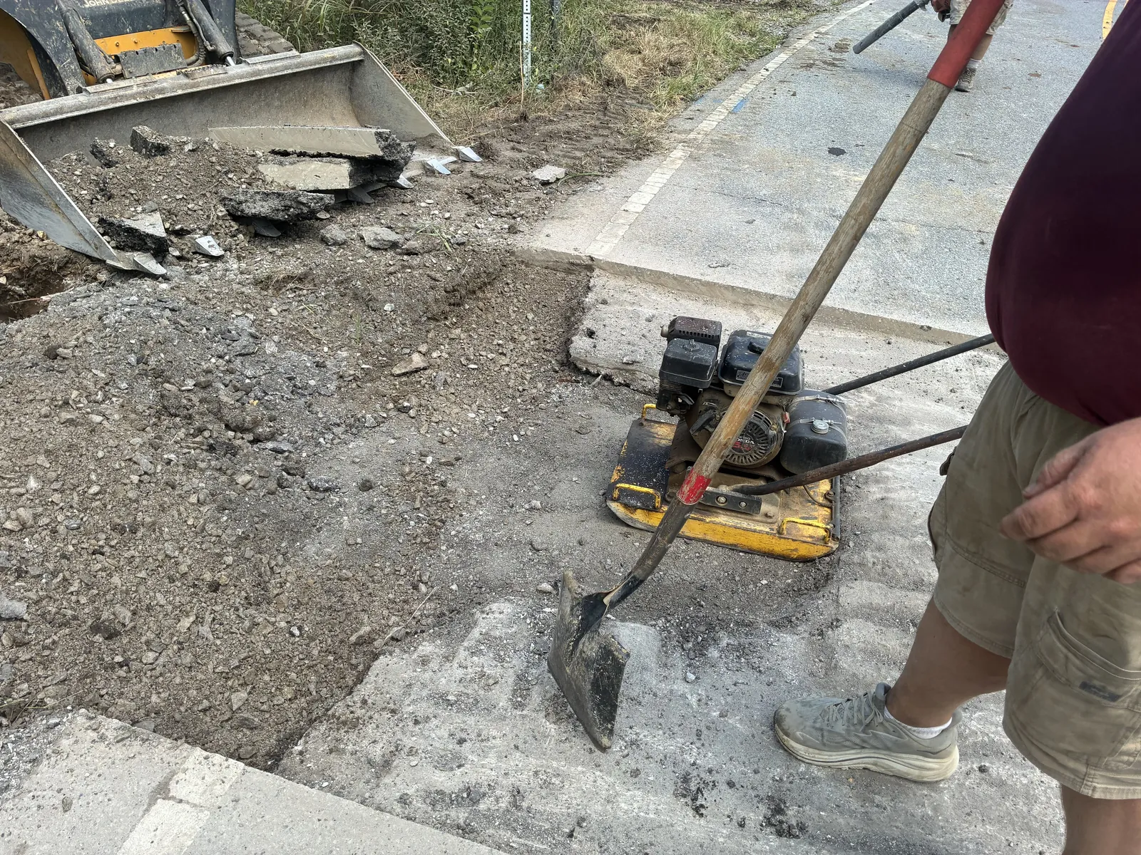 Septic services in Hartsville, TN: our crew compacting the base of a sewer line road cut before the patch
